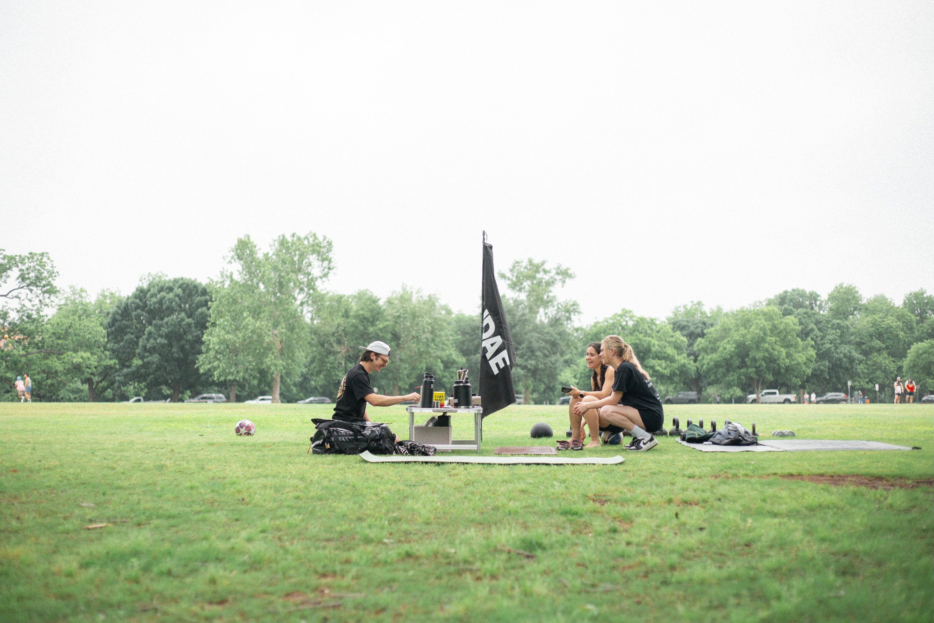 Group of fitness enthusiasts exercising outdoors at Zilker Park, Austin, Texas, promoting YUDAE Wellness community.